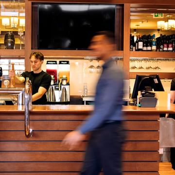 Photos of team members working in the restaurant, with a team member walking fast.